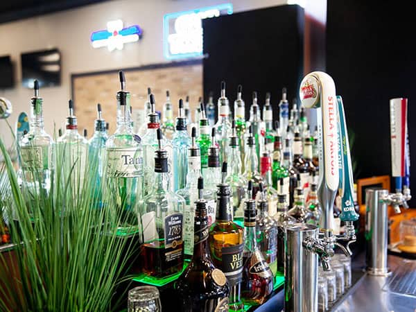 Tiered liquors and draft beer taps behind the bar at Jay’s Smokin BBQ in Punta Gorda